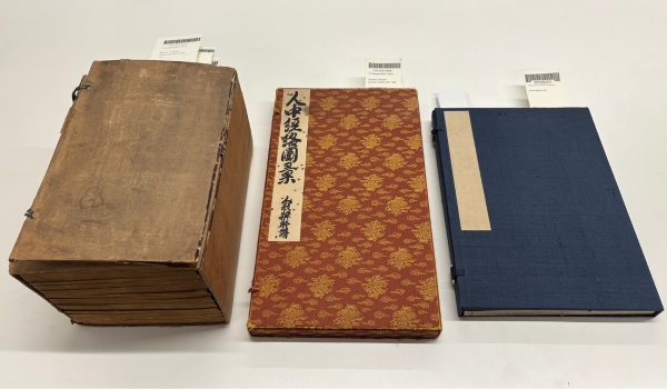 Three books arranged in a row on a table