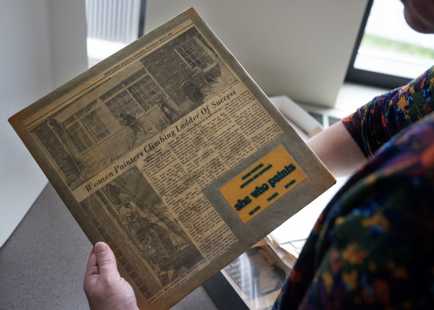 Person holds newspaper