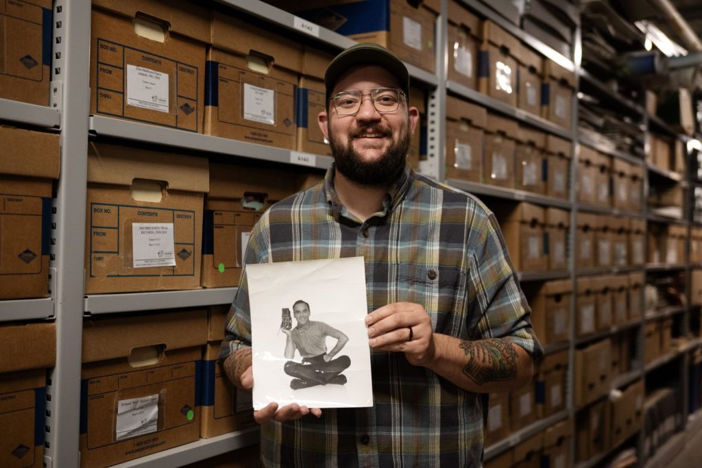 Aiden Bettine, curator of the Tretter Collection, poses with a photo of Roy Blakey, on Friday, May 22, 2026, in Minneapolis, Minnesota. (Photo/Adria Carpenter)