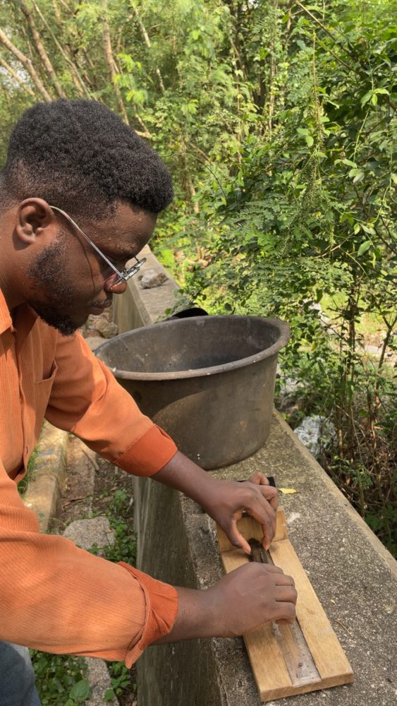Man handles a fish and mesures it.